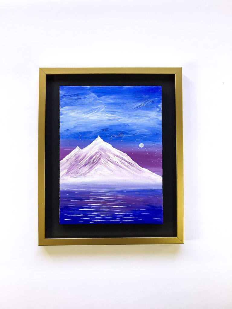 Painting of glimmering water sitting below a magnificent violet snow-capped mountain, a vibrant blue sky looms overhead.